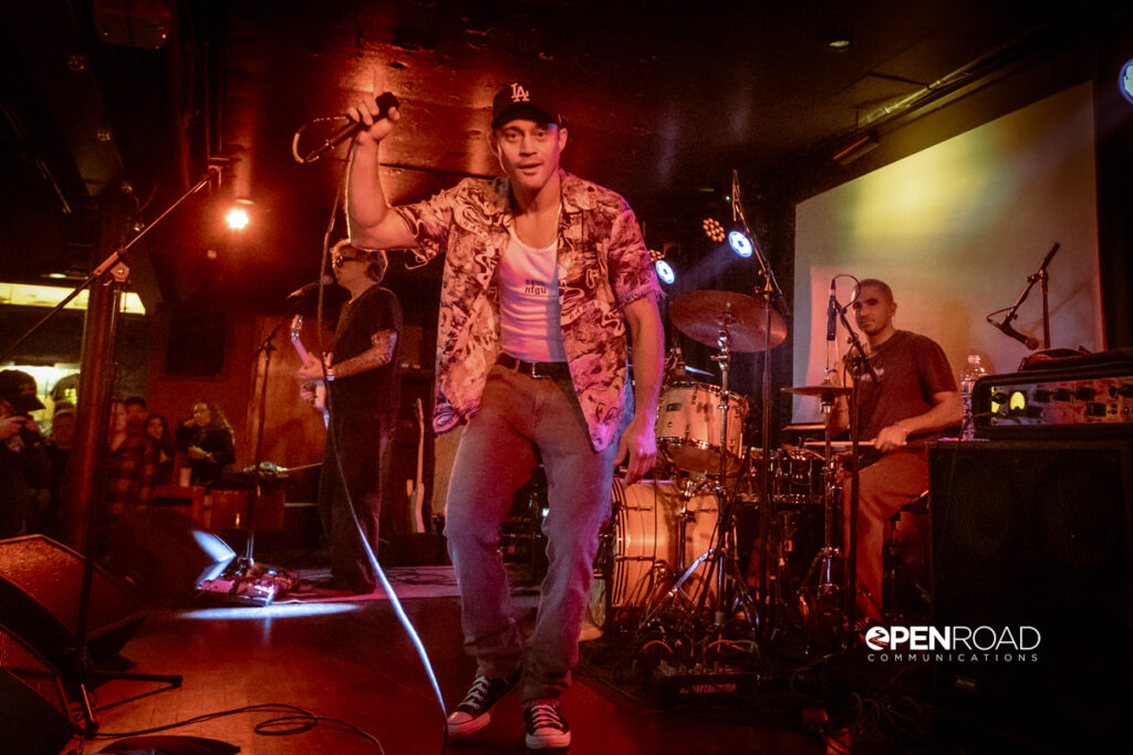 Makua bathed in red lights on stage