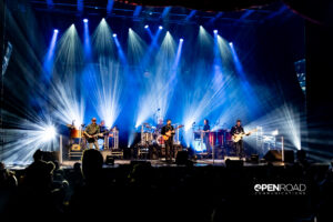 Wide photo of Umphrey's McGee bathed in bright white lights on stage at The Pageant.