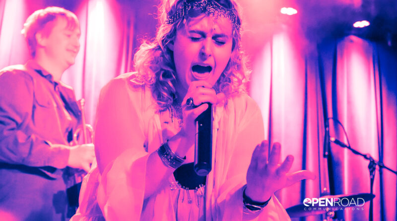 Boys Go To Jupiter' Jess Kantorowitz singing and bathed in pink hues