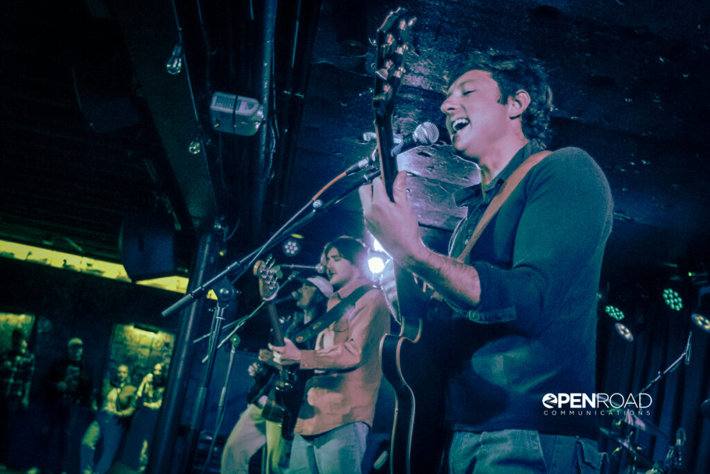 Side angle of members of Easy Honey singing on stage