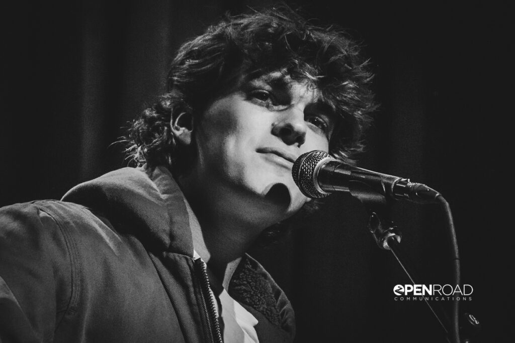 Hudson Ingram sings into the microphone