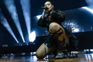 Tati Shmayluk of Jinger kneels on stage during their Duel tour in St. Louis