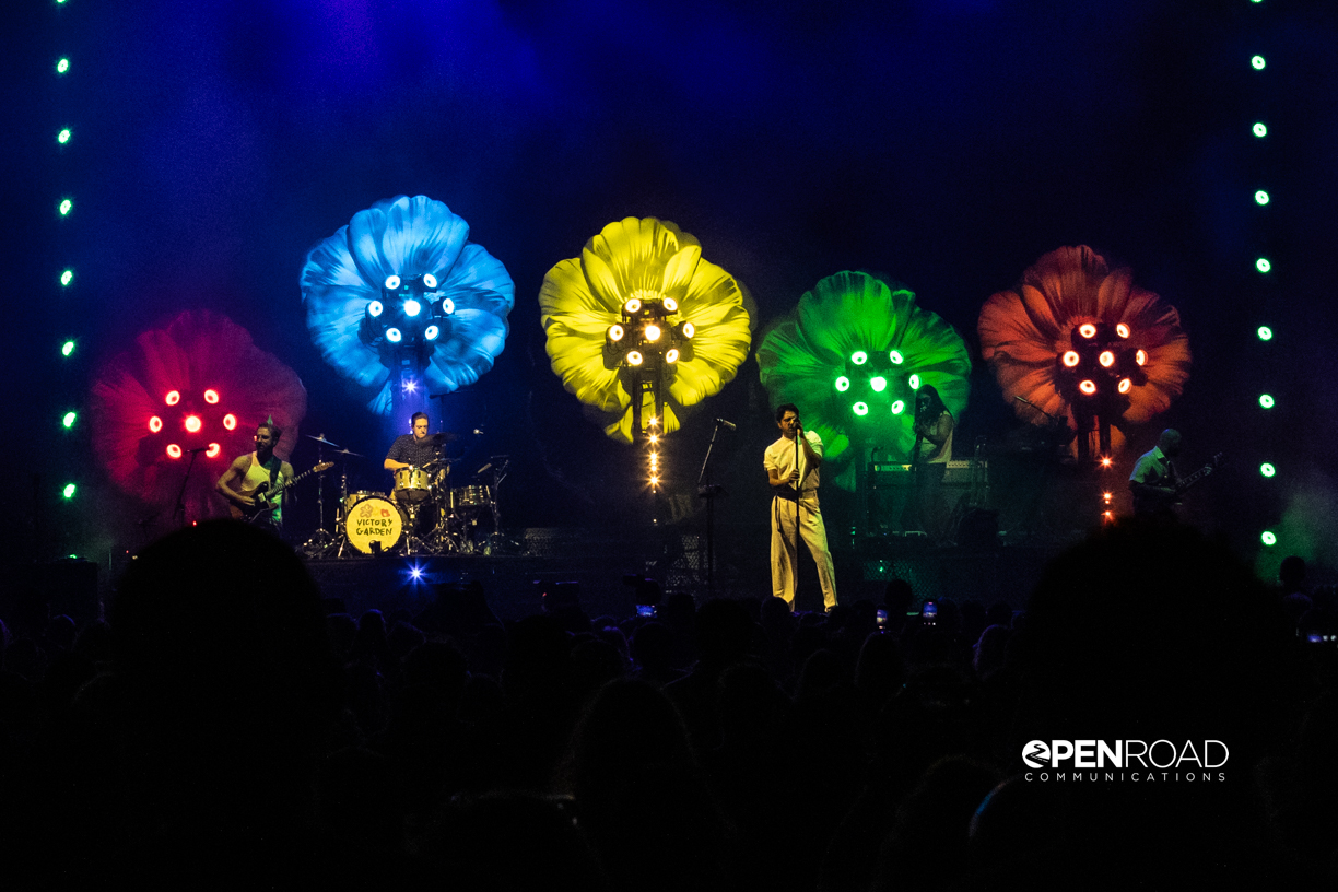 Far away image of Young the Giant on their Victory Garden Tour showing the floral backdrop