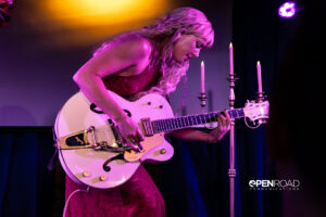 Iluka bending over her guitar during her The Wings Tour set in St. Louis