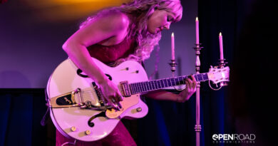Iluka bending over her guitar during her The Wings Tour set in St. Louis