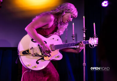 Iluka bending over her guitar during her The Wings Tour set in St. Louis