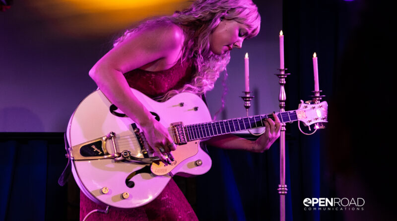 Iluka bending over her guitar during her The Wings Tour set in St. Louis