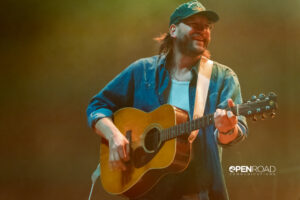 Carriers singer smiling with a guitar