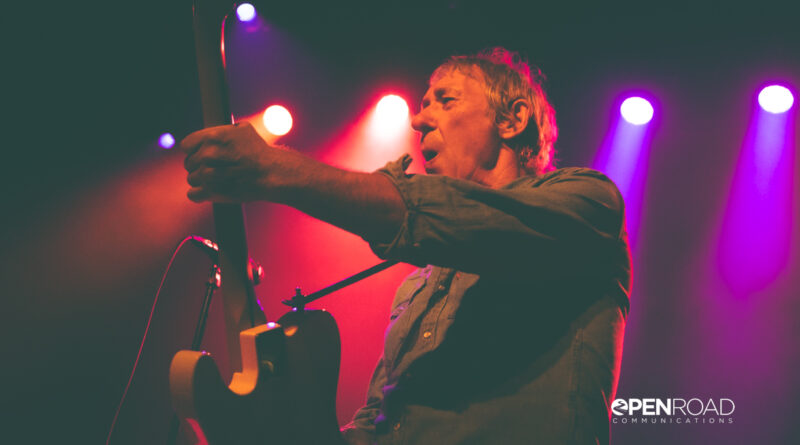Buzzcocks singer Steve Diggle playing guitar and singing